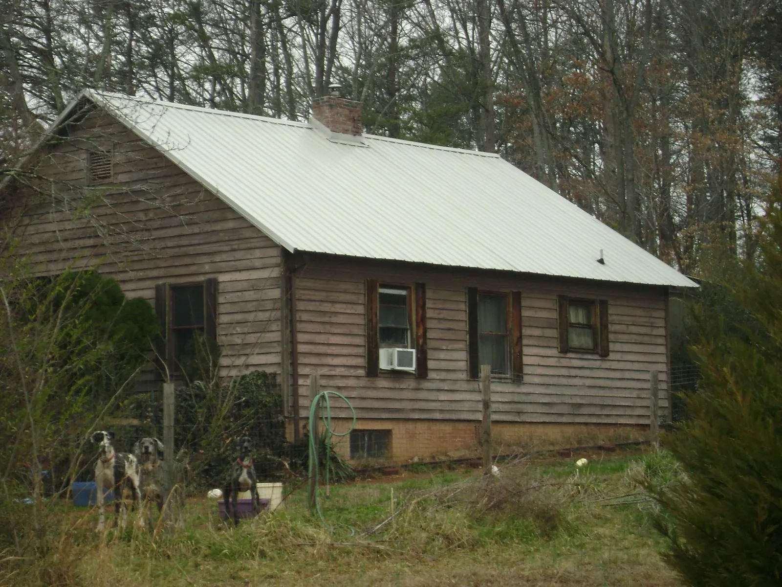 White metal roof on an old wood sided farmhouse, from a Metal Roof Installation job in East Spencer